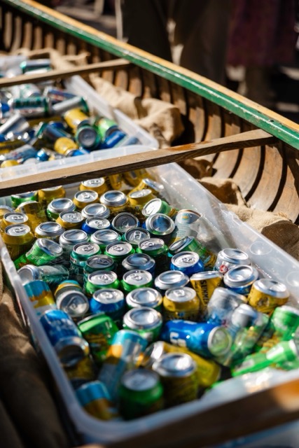 Close-up of a wooden canoe filled with iced craft beers, hard seltzers, and cold beverages for guests at a Camp Wigwam event